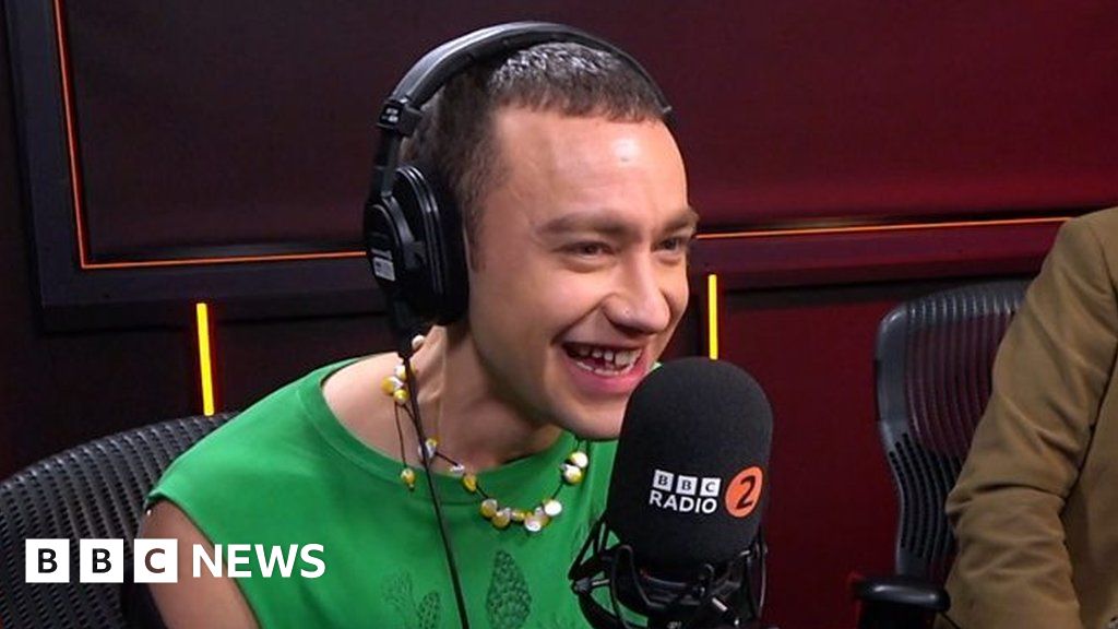 Beaming Olly Alexander unveils UK Eurovision song on Radio 2