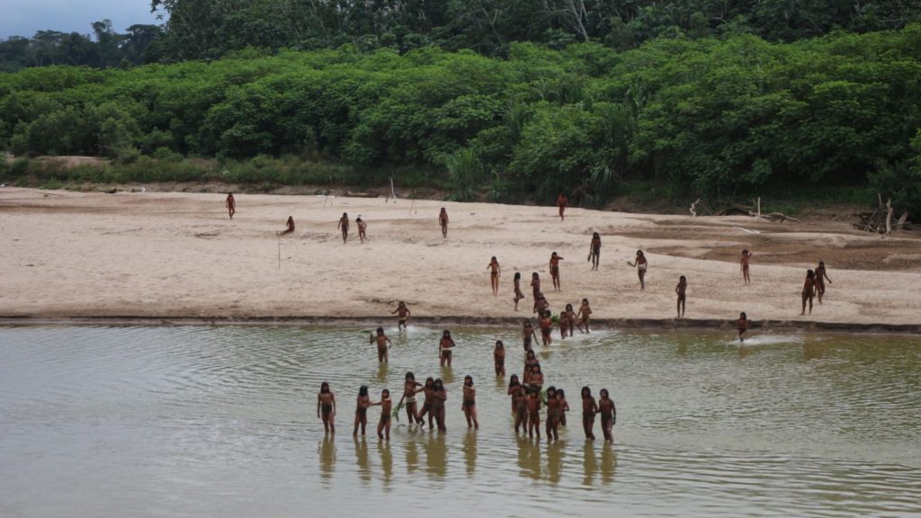 Rare new vid shows ‘uncontacted’ tribe living deep inside rainforest in Peru brandish spears on riverbank