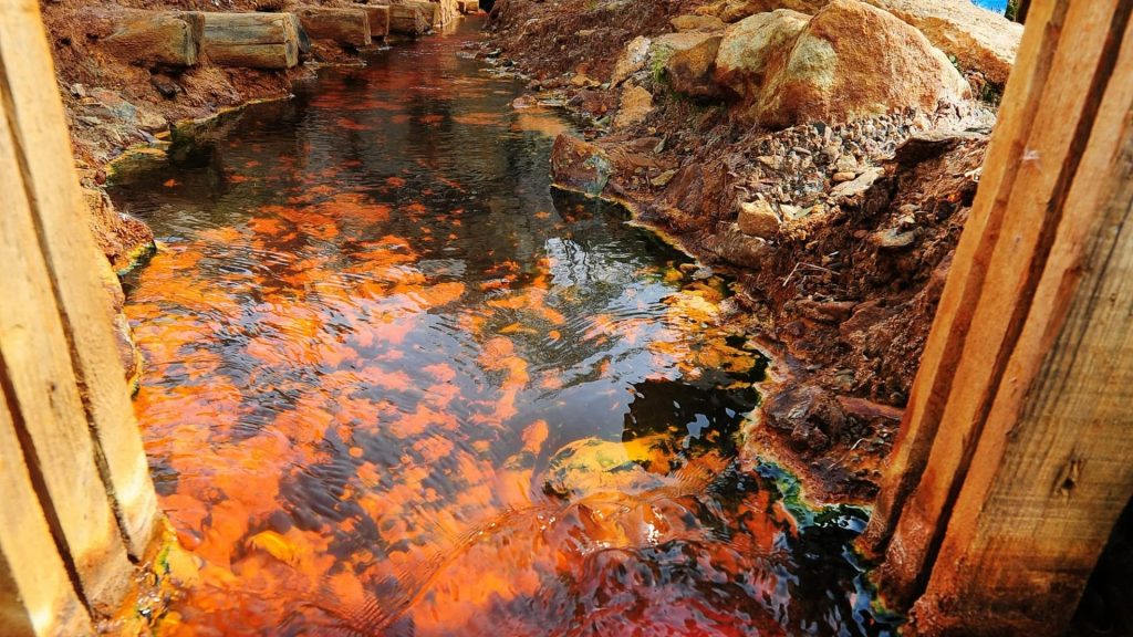 Inside world’s most toxic village swallowed by lake of lethal sludge with only steeple and roofs left above the surface