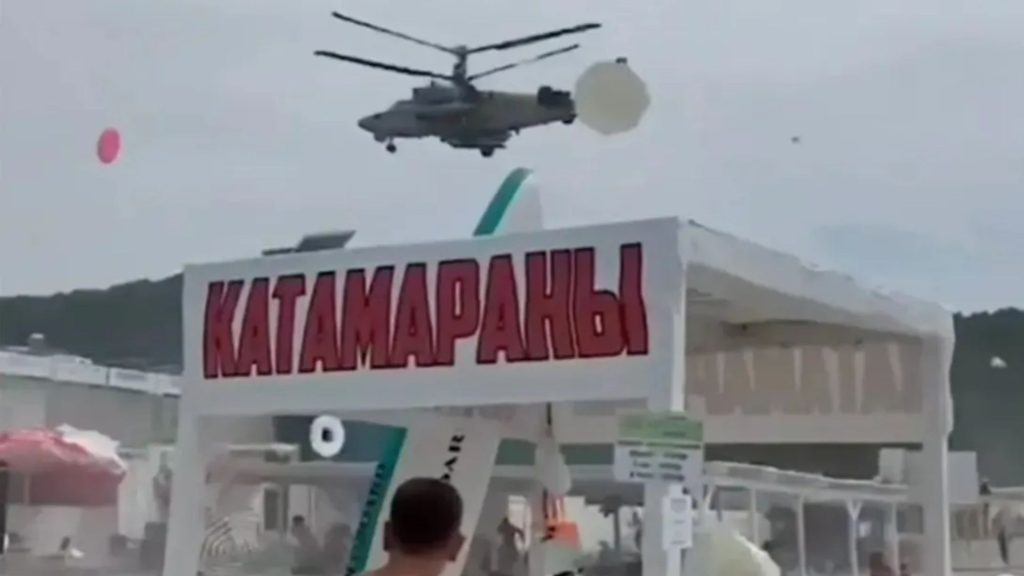 Watch moment Russian helicopters fly over packed Black Sea beach sending terrified tourists scrambling for cover – The Sun